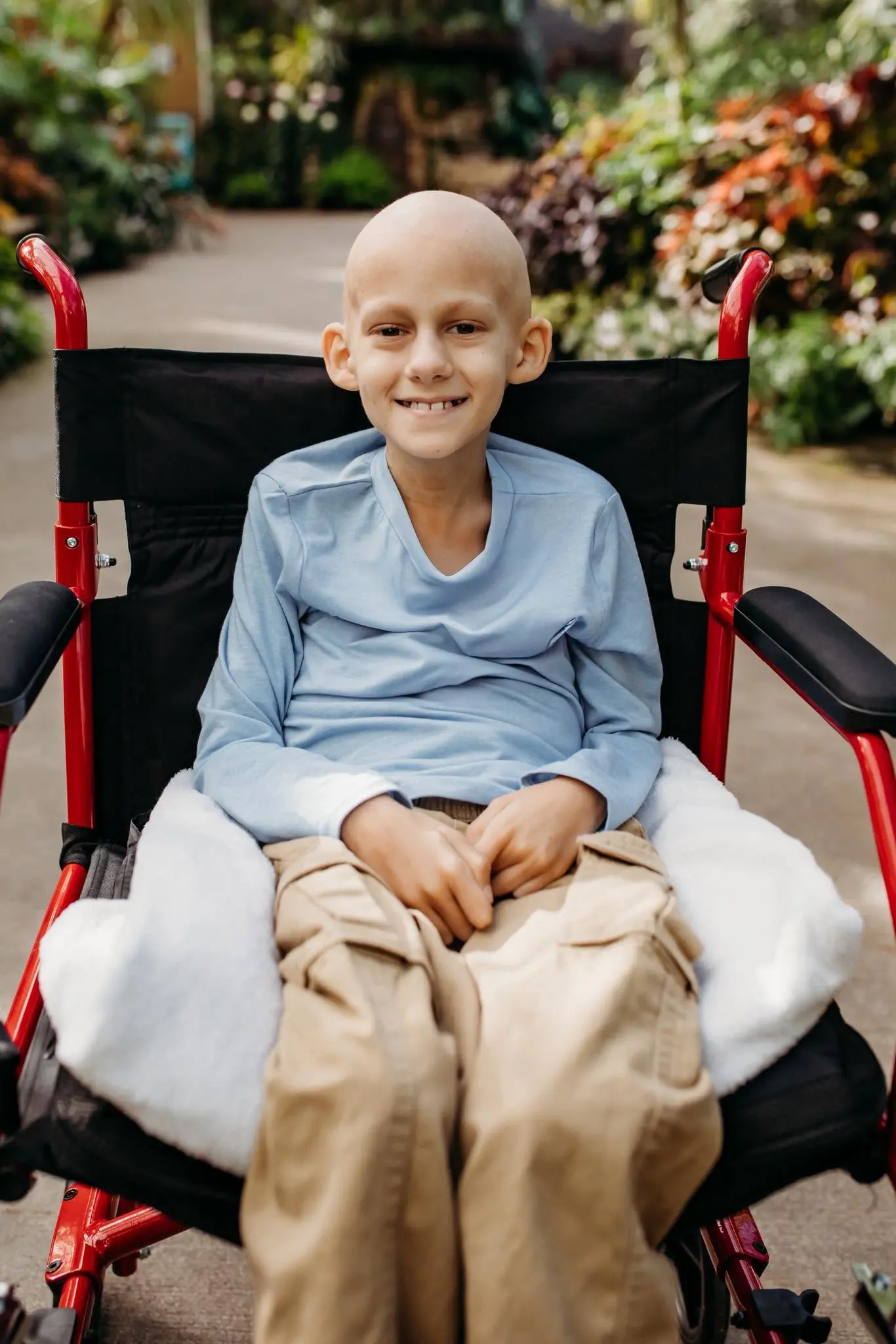 Gavin Springsteen smiling in his wheelchair in a garden